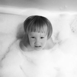 Portrait of shirtless boy in bathroom