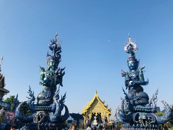 Statue of temple against building