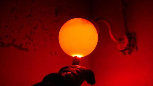 Close-up of hand holding illuminated lamp