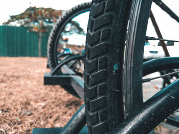 Close-up of metal wheel against sky