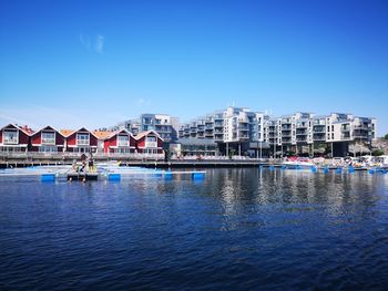 Scenic view of buildings against clear blue sky