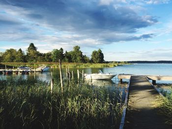 Jetty with boats by river