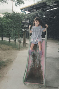 Portrait of girl standing against plants