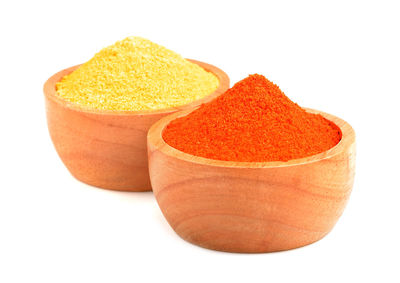 Close-up of fresh orange slices in bowl against white background