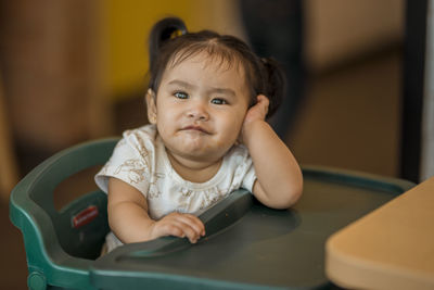 Portrait of cute baby girl sitting