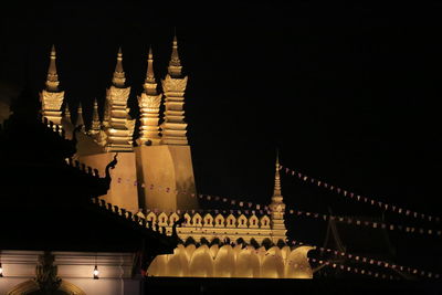 Illuminated building against sky at night