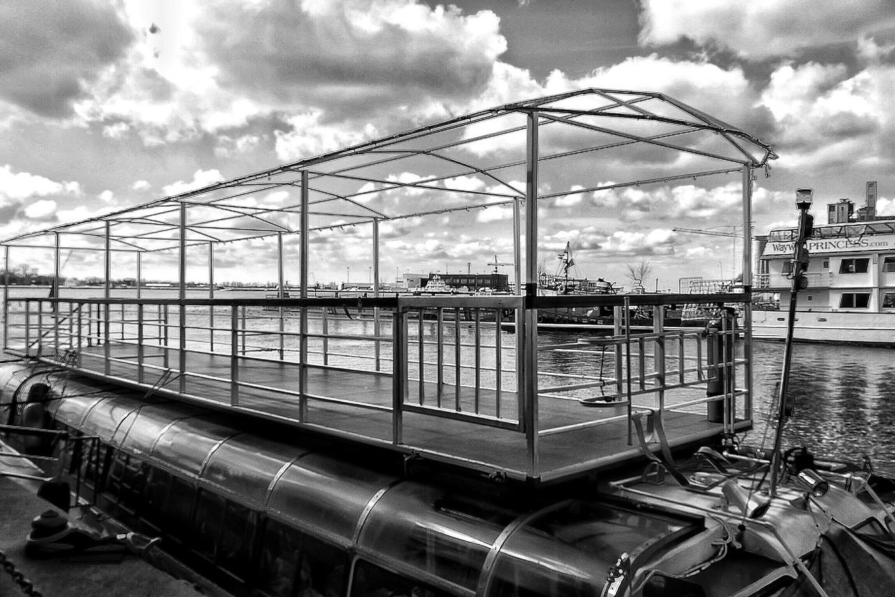 sky, cloud - sky, architecture, built structure, cloudy, metal, cloud, transportation, day, building exterior, amusement park ride, low angle view, no people, amusement park, ferris wheel, outdoors, arts culture and entertainment, metallic, mode of transport, travel