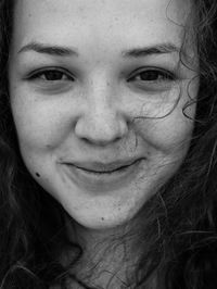 Close-up portrait of a smiling young woman