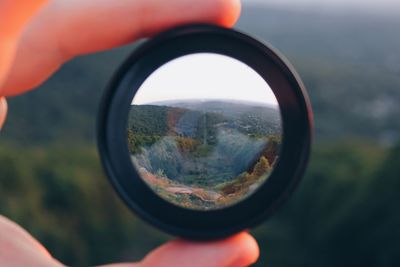 Close-up of man photographing through camera