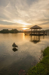 Scenic view of lake against sky during sunset