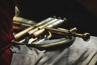 Close-up mid section of man with musical instrument