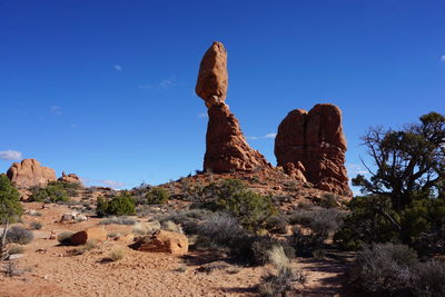 Rock formation on land against blue sky