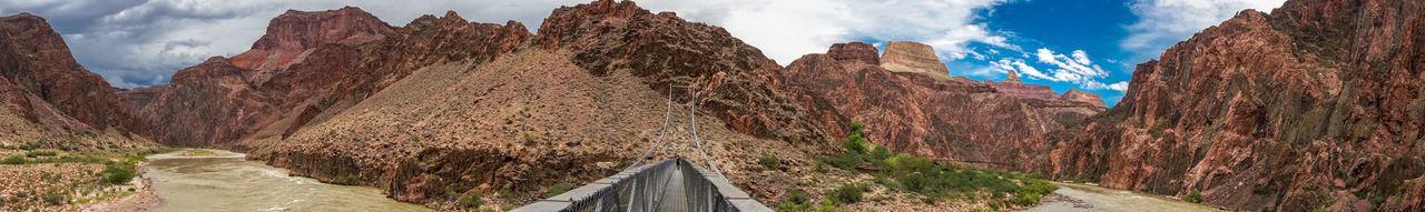 Panoramic view of road amidst mountains against sky