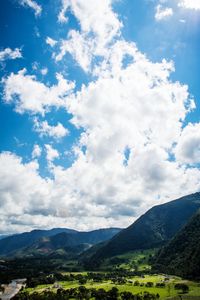 Scenic view of mountains against cloudy sky