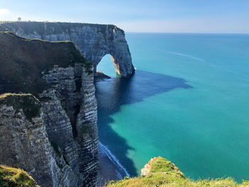 Rock formations by sea against sky