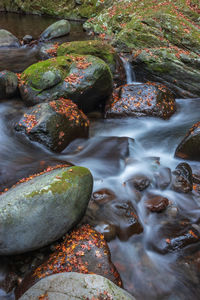 High angle view of stream flowing through rocks