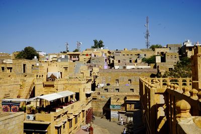 Residential buildings against clear blue sky