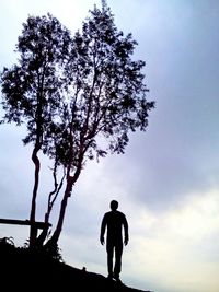 Rear view of silhouette man against sky