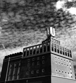 Low angle view of building against cloudy sky