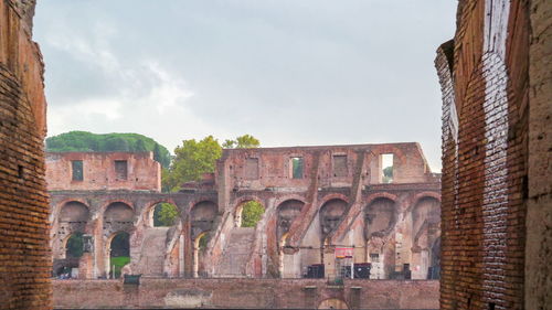 Arch bridge against cloudy sky