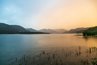 Scenic view of lake against sky during sunset
