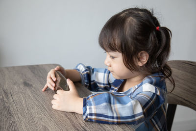 Cute girl sitting on sofa at home