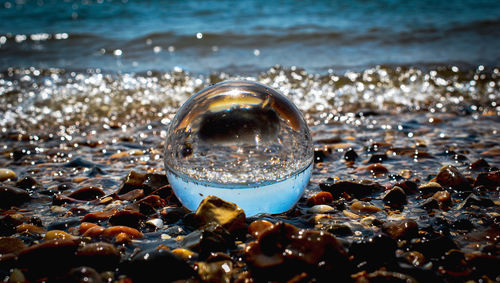 Close-up of crystal ball in the sea