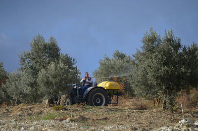 Tractor on field against sky