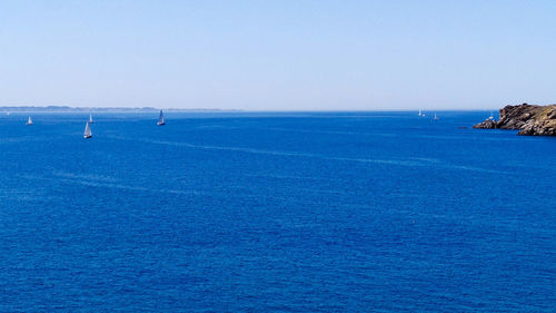 Scenic view of sea against clear blue sky