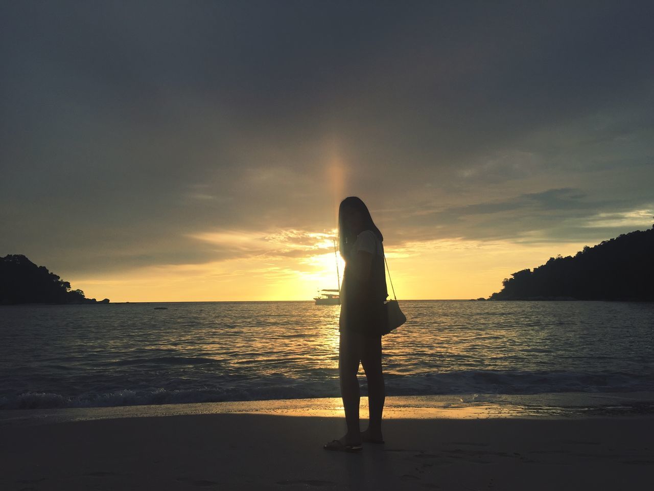 sky, sunset, water, sea, beauty in nature, scenics - nature, silhouette, land, real people, one person, standing, horizon over water, beach, horizon, orange color, leisure activity, cloud - sky, lifestyles, nature, outdoors