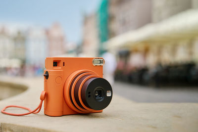 Vintage orange instant camera. travel shooting equipment