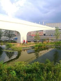 Arch bridge over river against sky