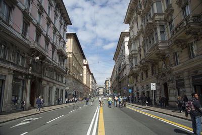 Vehicles on road amidst buildings in city