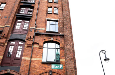 Low angle view of street light against building