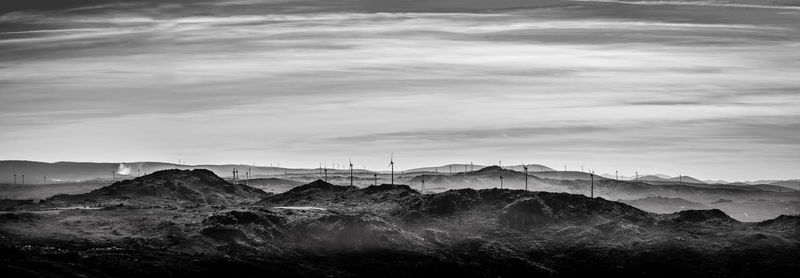 Scenic view of mountains against cloudy sky