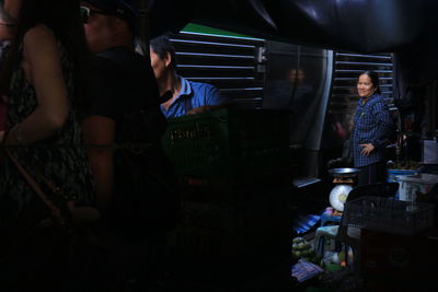 People standing in market at night