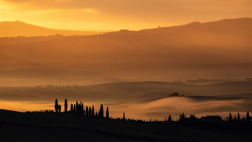 Scenic view of silhouette landscape against sky during sunset