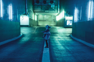 Woman standing in illuminated building