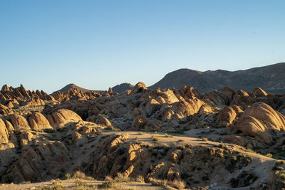 Scenic view of rocky mountains against clear sky