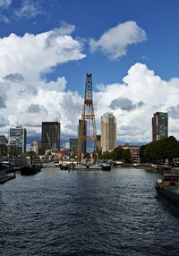 River by buildings against sky in city