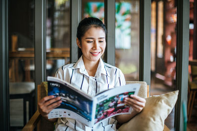 Young woman reading book