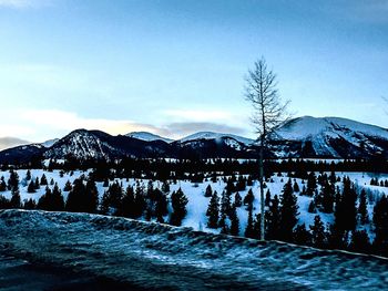 Scenic view of snowcapped mountains against sky during winter