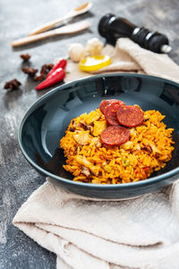 Close-up of food in bowl by ingredients on table