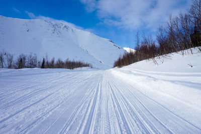 Snow covered landscape against sky