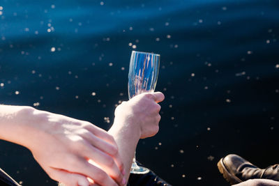 Midsection of woman holding umbrella
