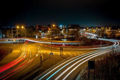 High angle view of light trails on road at night