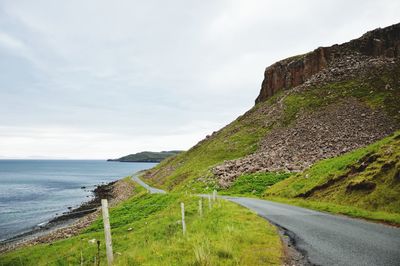 Road by sea against sky