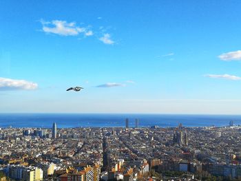 Aerial view of sea and buildings in city