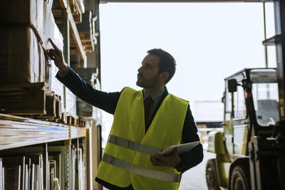 Man in warehouse supervising stock