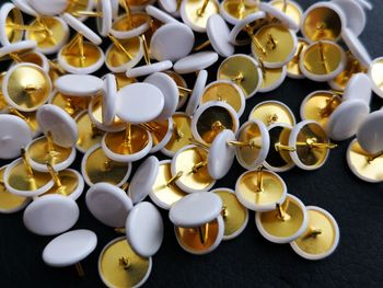 High angle view of thumbtacks on table